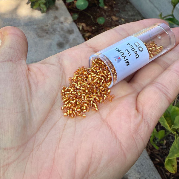 30g Miyuki Delica 11/0 Seed Beads, Transparent Silver-Lined Marigold DB1201