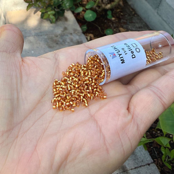 30g Miyuki Delica 11/0 Seed Beads, Transparent Silver-Lined Marigold DB1201